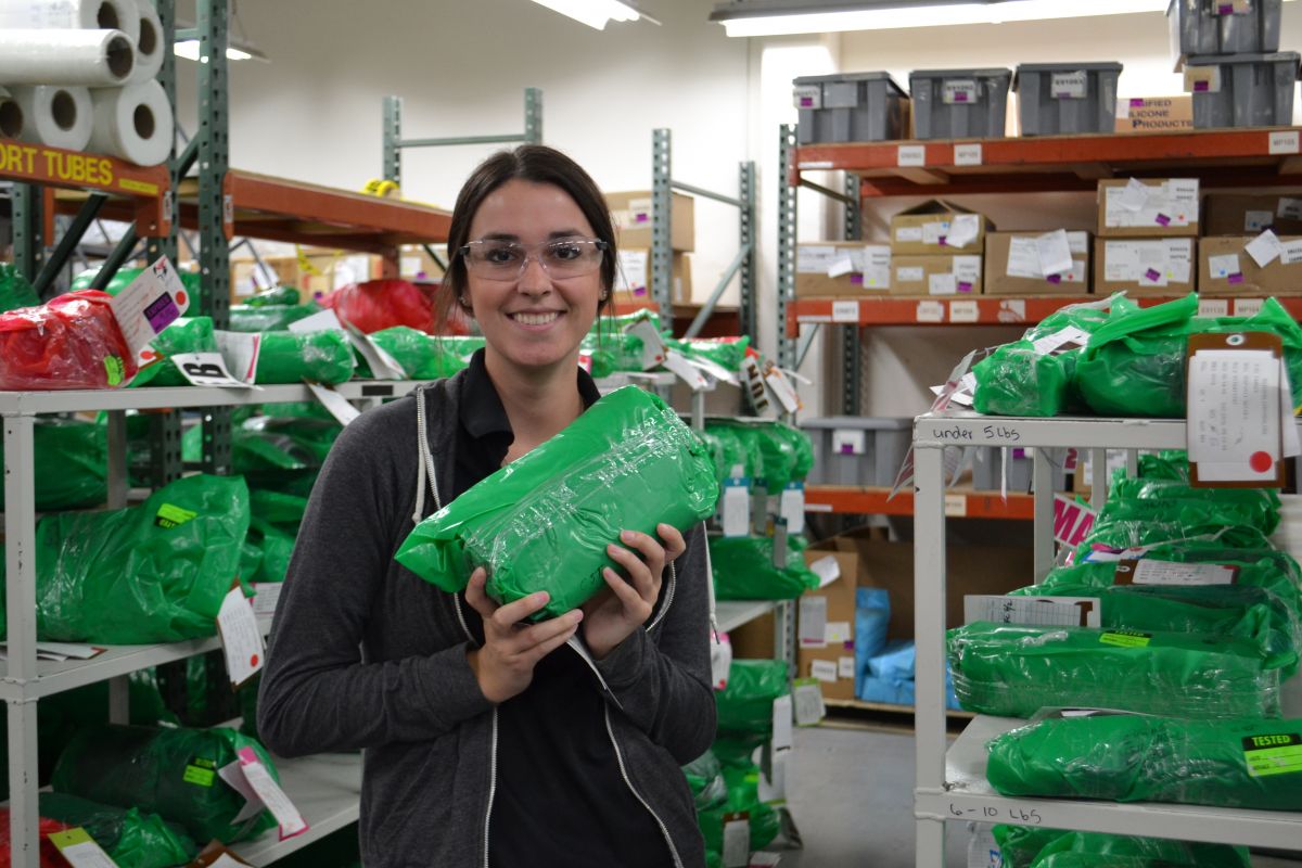 A McMinnville WORKS Intern holds a bag of silicone