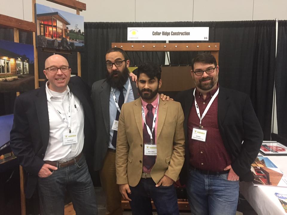 Abhi stands with the Cellar Ridge team at a building conference in Portland