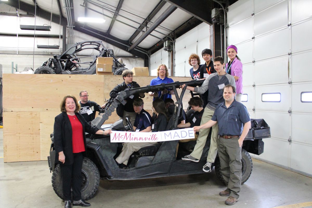 McMinnville High School Students and McMinnville City Councilor, Kellie Menke, jump into a RP Advanced Mobile Systems UTV
