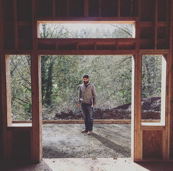 Abhi stands in the frame of his first official project, a house for a McMinnville resident. 