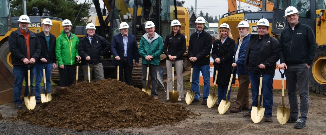 A group of community members vital to the creation and development of Alpine Avenue celebrate the groundbreaking with golden shovels.
