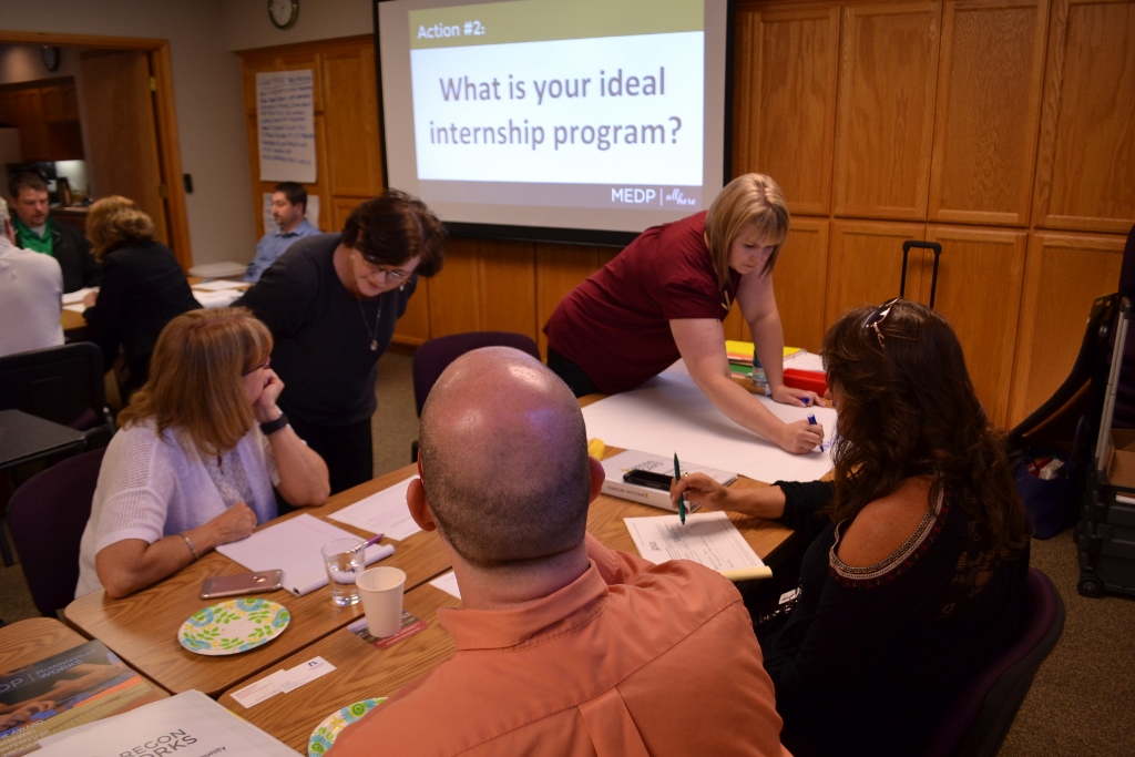 Participants in Albany write down the components they believe would create an ideal internship program