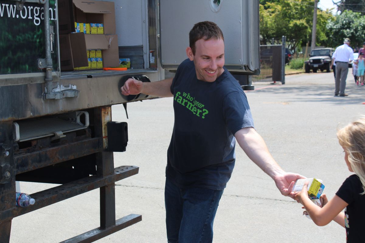 General Manager Scott Fields gives out butter to the McMinnville community  at the company’s grand opening.