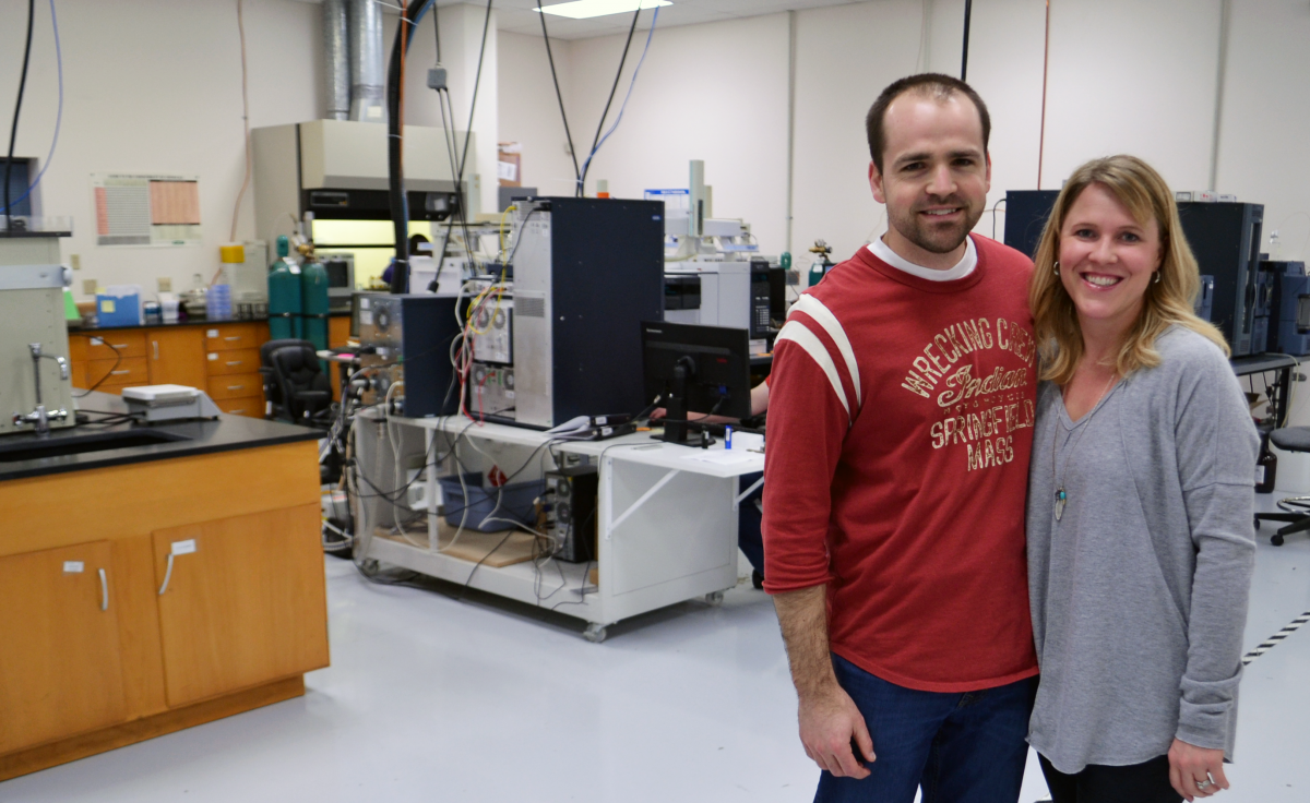 Mark Newman stands with his wife in the Precision Analytical lab