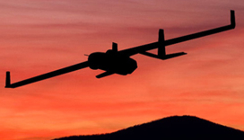 A drone flies over a sunset