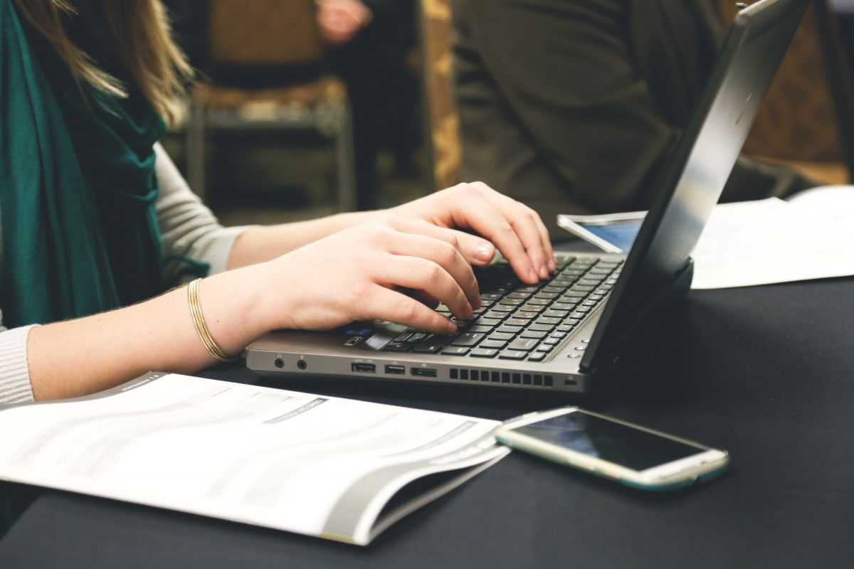 A woman typing on a computer